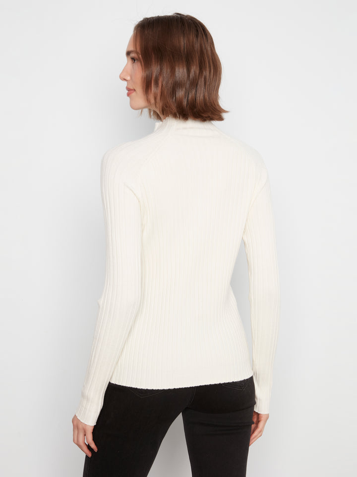 A woman shown from the back wearing a ribbed cream mock neck long-sleeve top and black pants, photographed against a plain light gray studio background.