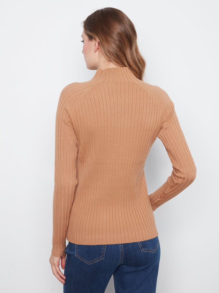 A woman shown from the back wearing a ribbed long-sleeve mock neck sweater in a warm camel tan color, paired with blue jeans, against a plain white studio background.