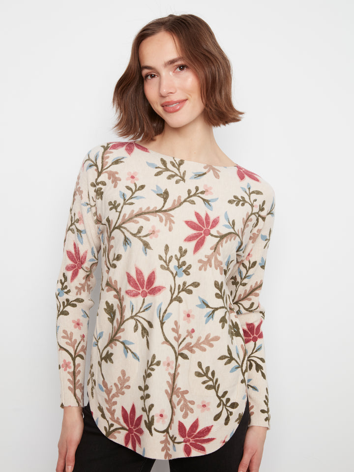 Woman wearing a floral patterned top on a white background
