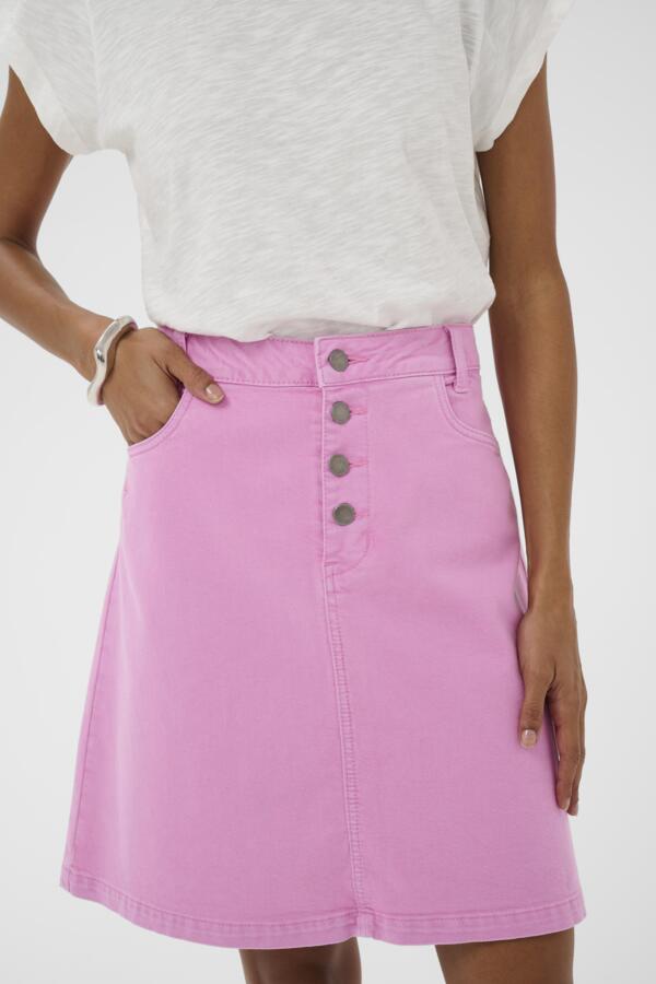 Person wearing a pink skirt with button details on a white background
