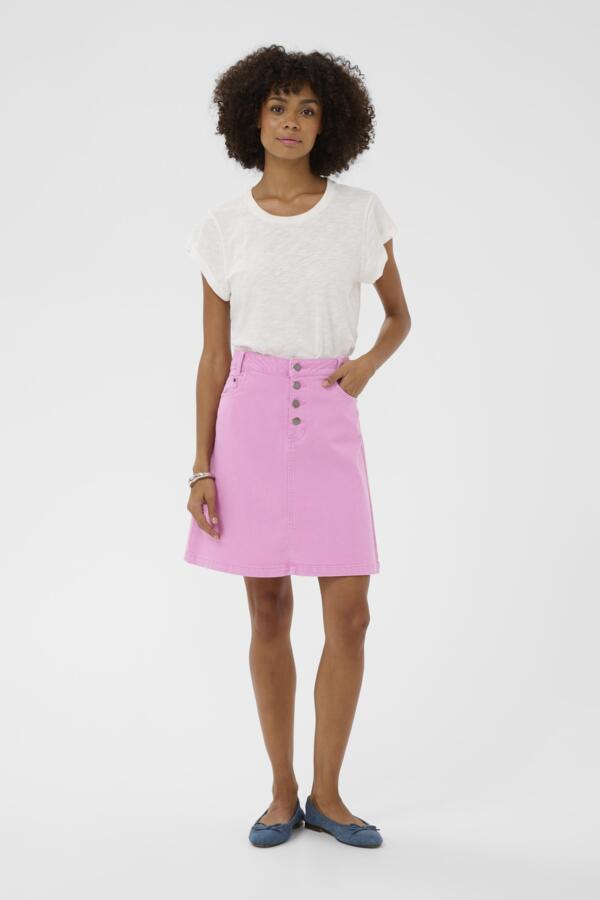 Woman wearing a white top and pink skirt on a white background