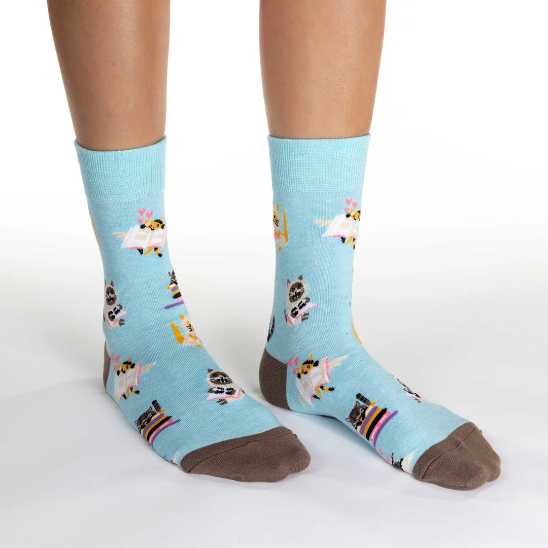 Light blue socks with animal pattern worn by a person on a white background