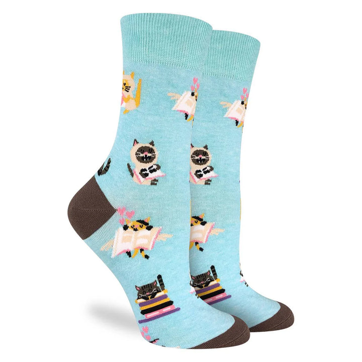 Light blue socks with cartoon cat designs on a white background