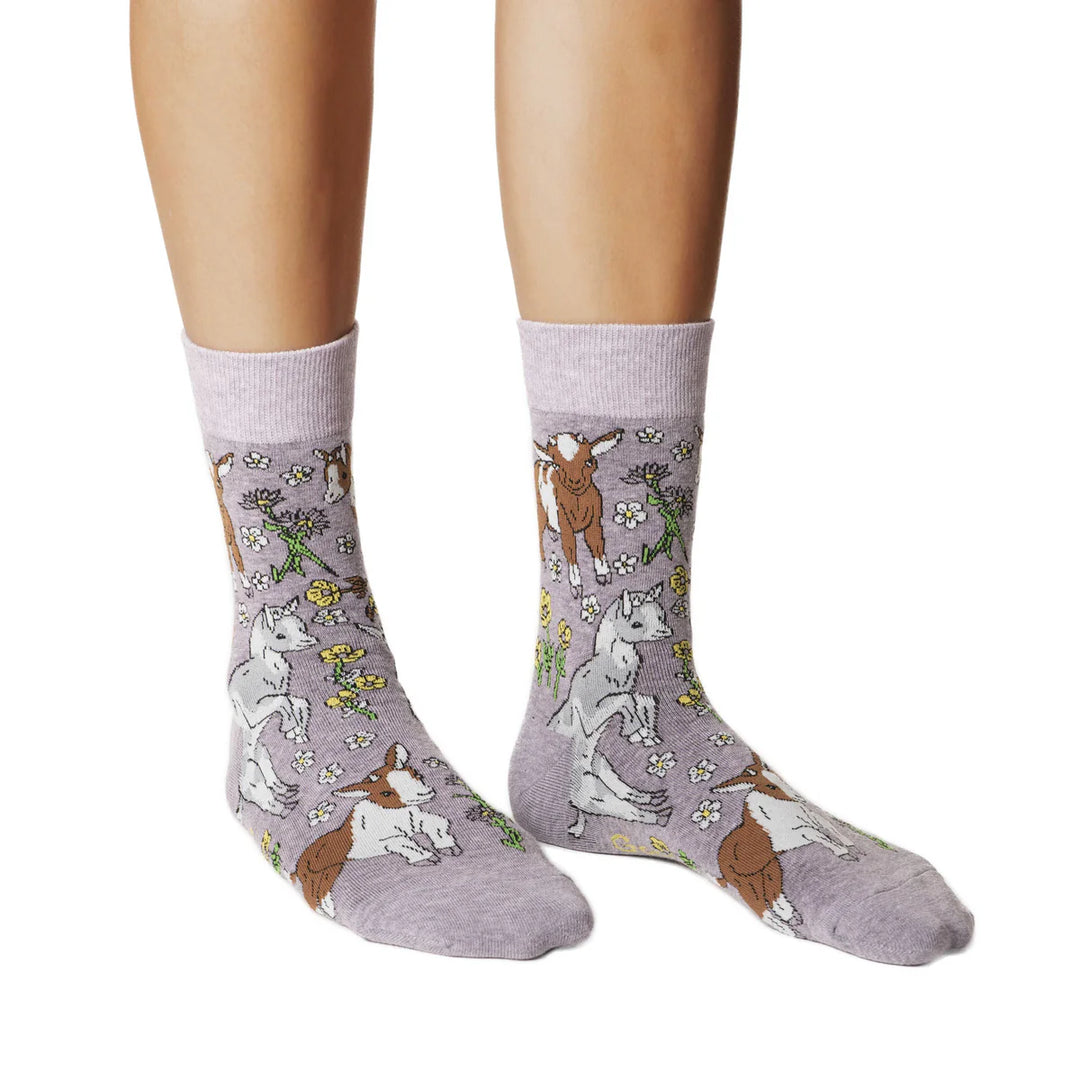 Gray socks with animal pattern worn by a person on a white background