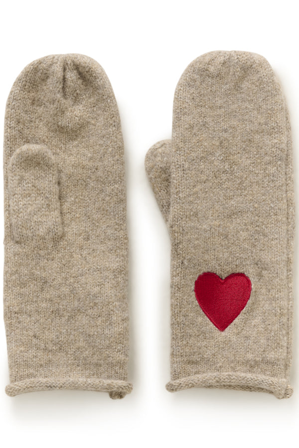 A pair of knit winter mittens in a heathered oatmeal-beige color, featuring a red felt heart patch on the back of one mitten.