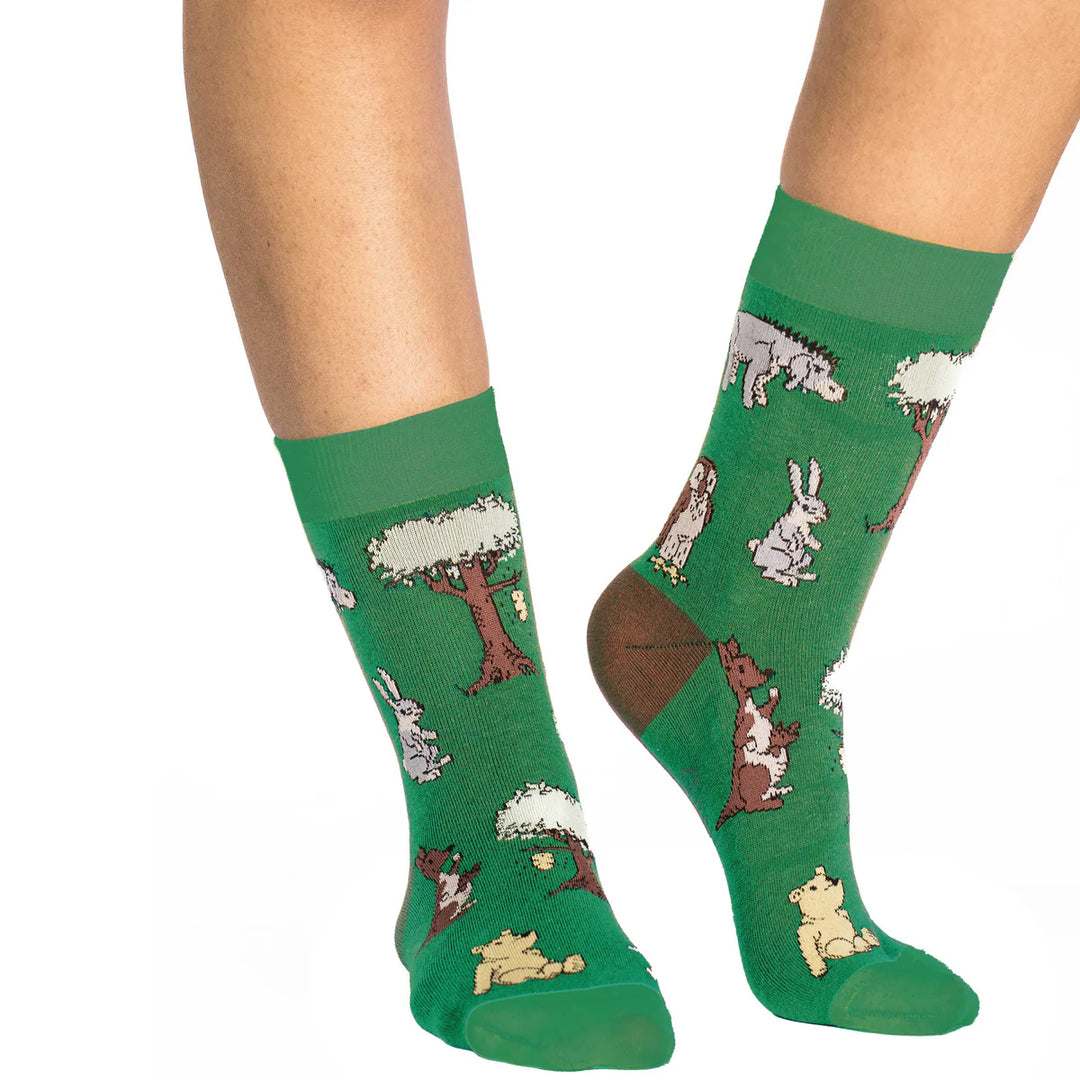 Green socks with animal pattern worn by a person on a white background