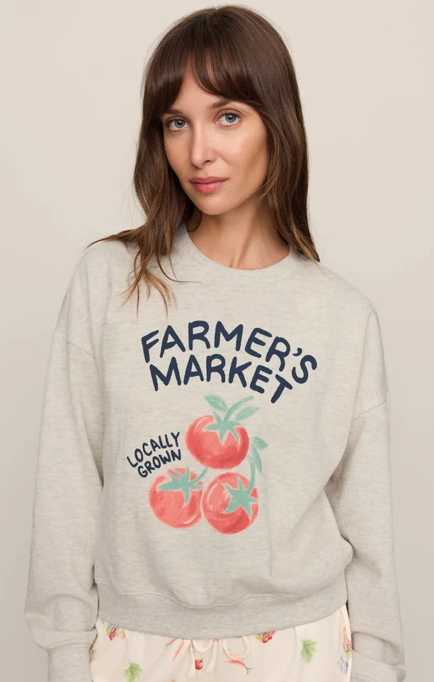 Woman wearing a gray sweatshirt with &