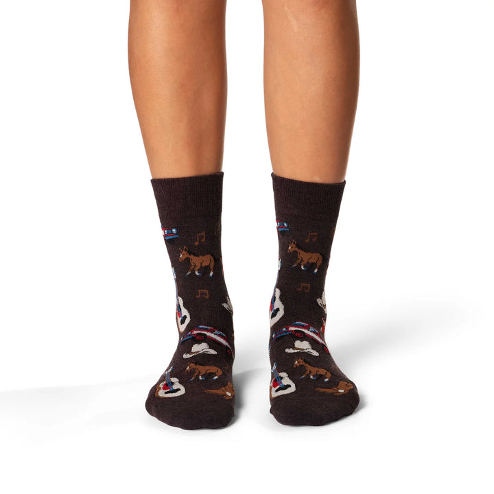 Brown socks with animal and music note patterns worn by a person on a white background