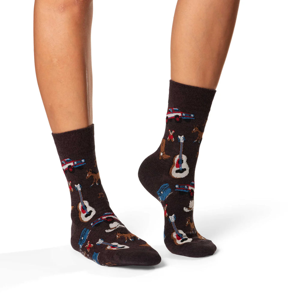 Brown socks with musical instrument pattern worn by a person on a white background