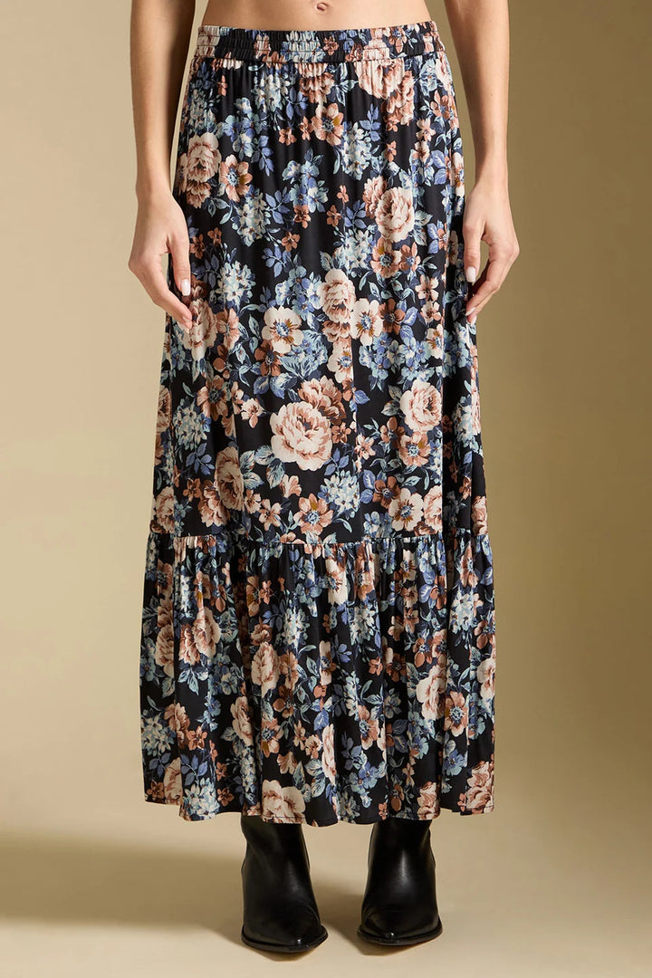 Floral patterned skirt worn by a person on a beige background