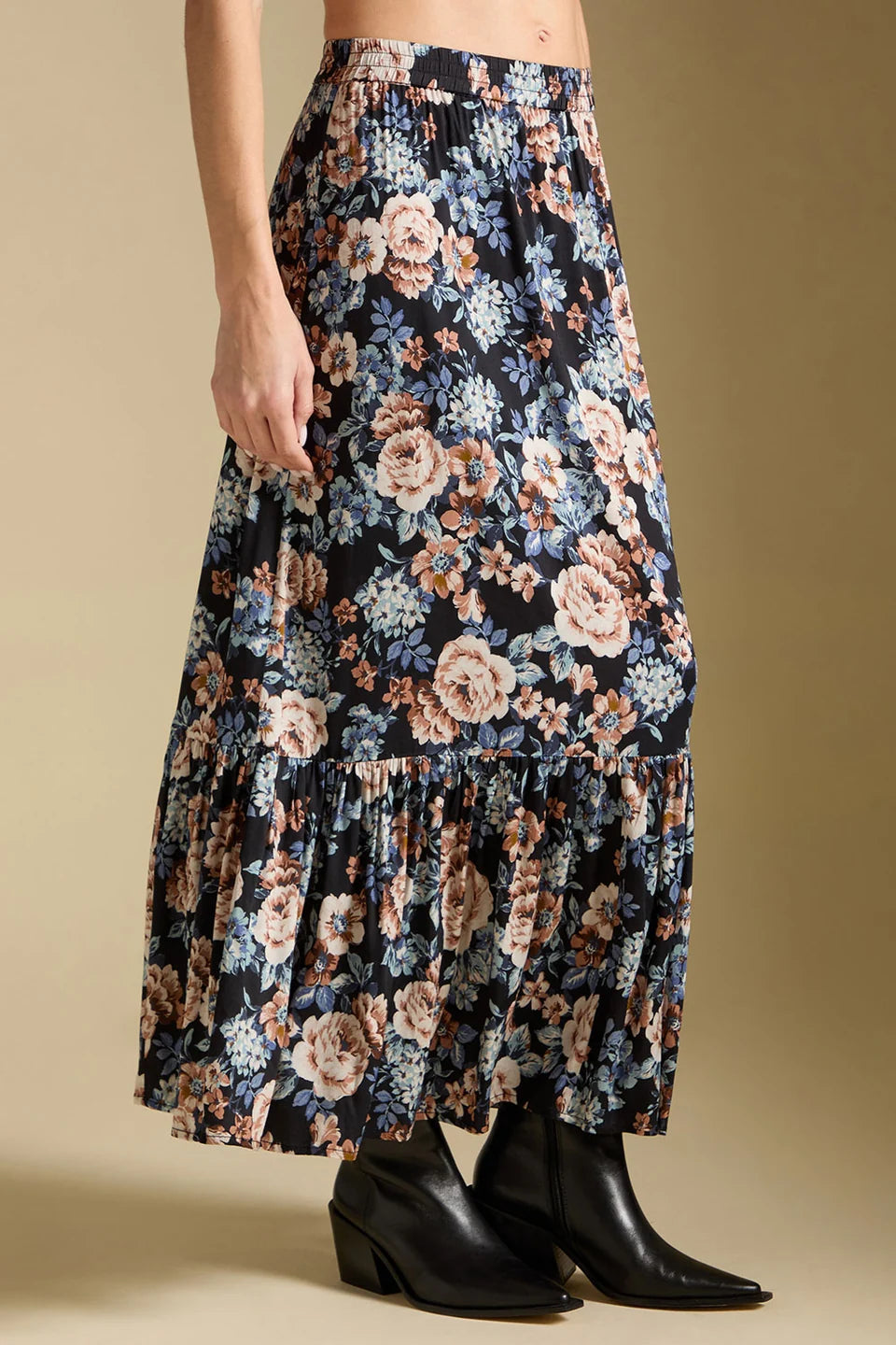 Floral skirt worn by a person on a beige background