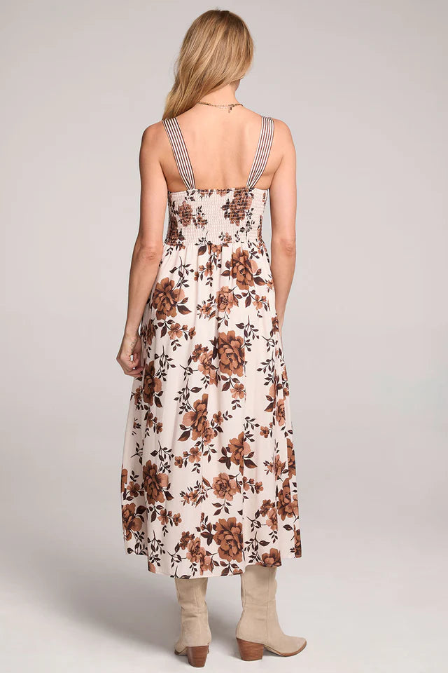 Woman wearing a floral dress with a plain background