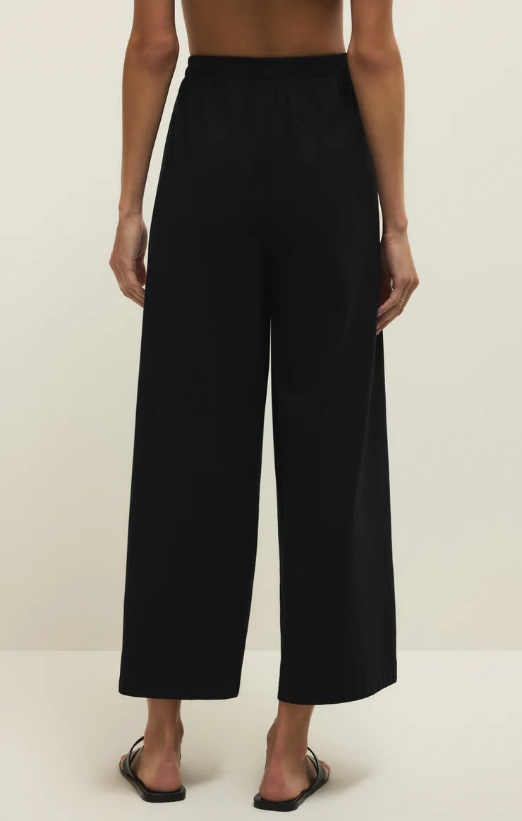 Black wide-leg pants worn by a person on a plain background