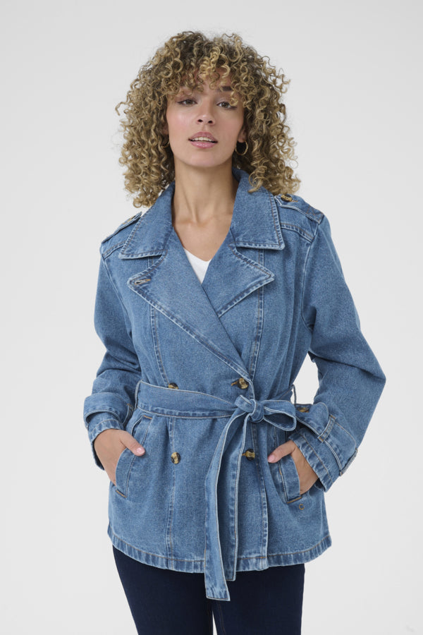 Woman wearing a blue denim jacket on a white background