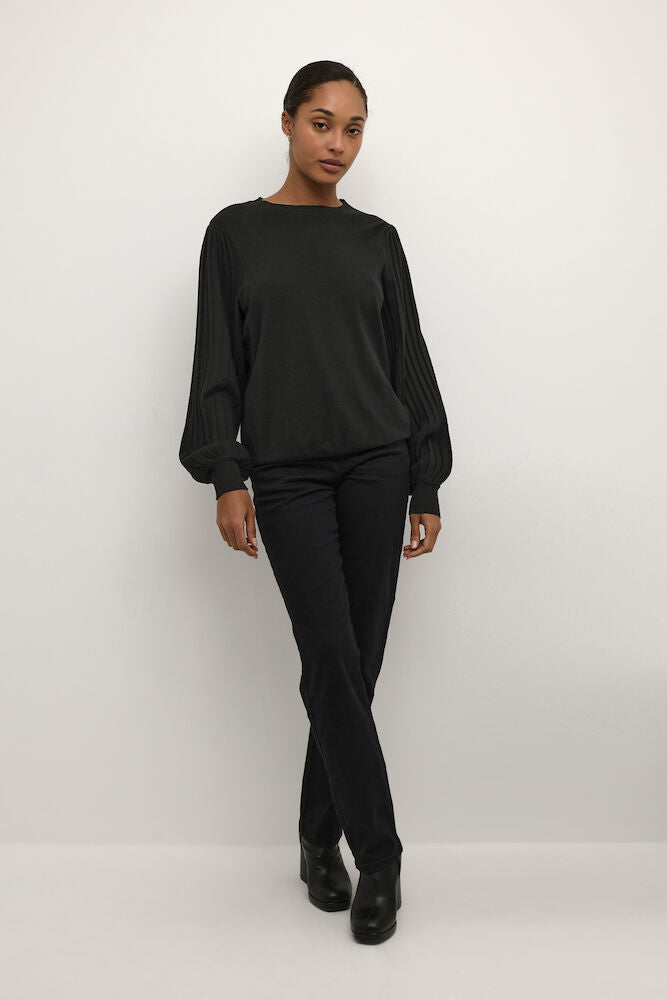 Person wearing a black outfit against a white background
