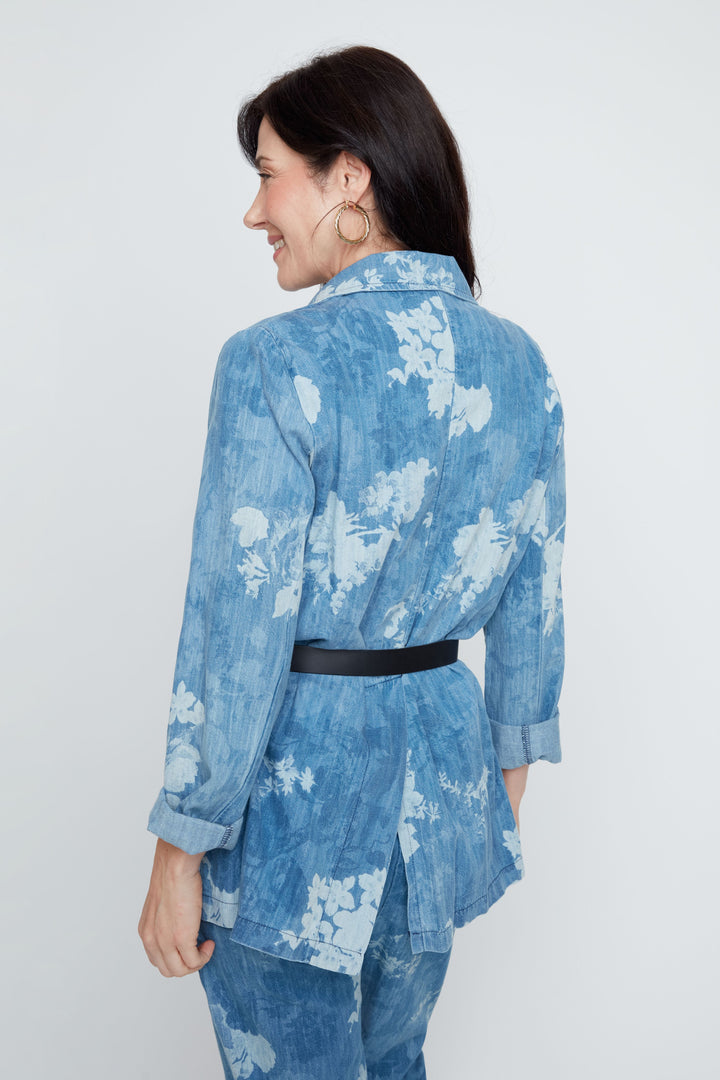 Woman wearing a blue floral kimono-style outfit on a white background