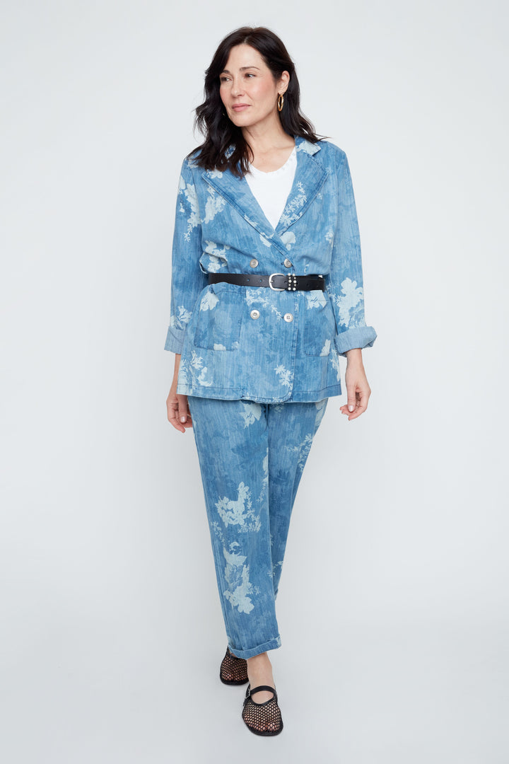 Woman wearing a blue floral suit on a white background