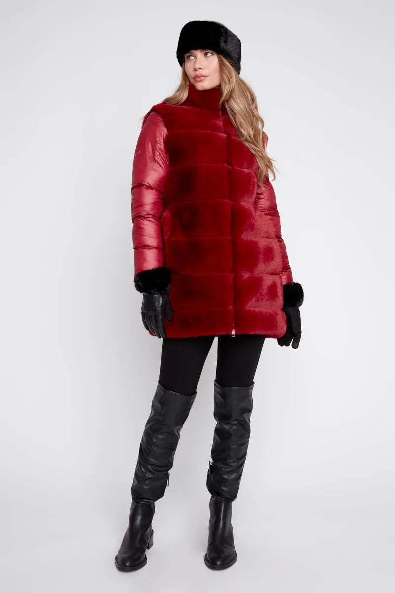 Person wearing a red puffer coat, black gloves, and black boots on a white background