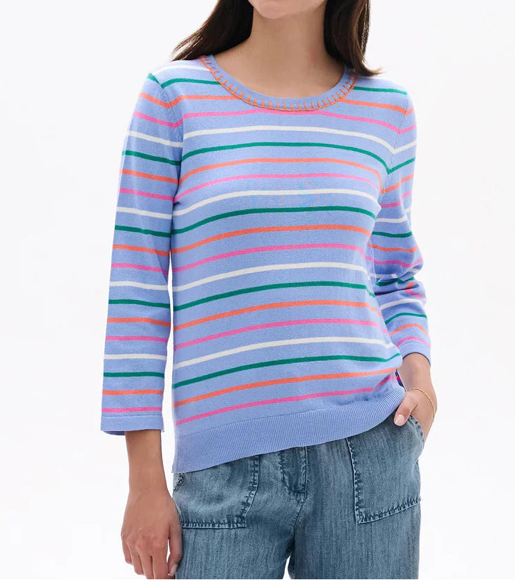 Woman wearing a colorful striped sweater on a white background
