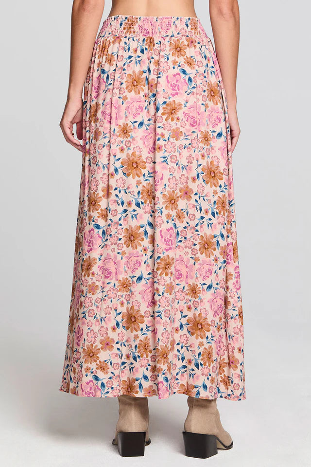 Floral patterned skirt worn by a person on a plain background