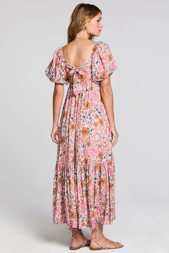 Woman wearing a floral dress on a plain background