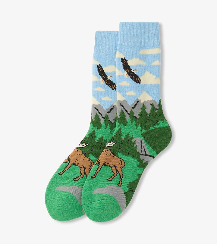 Socks with nature-themed design featuring a deer, trees, and mountains on a light blue background.