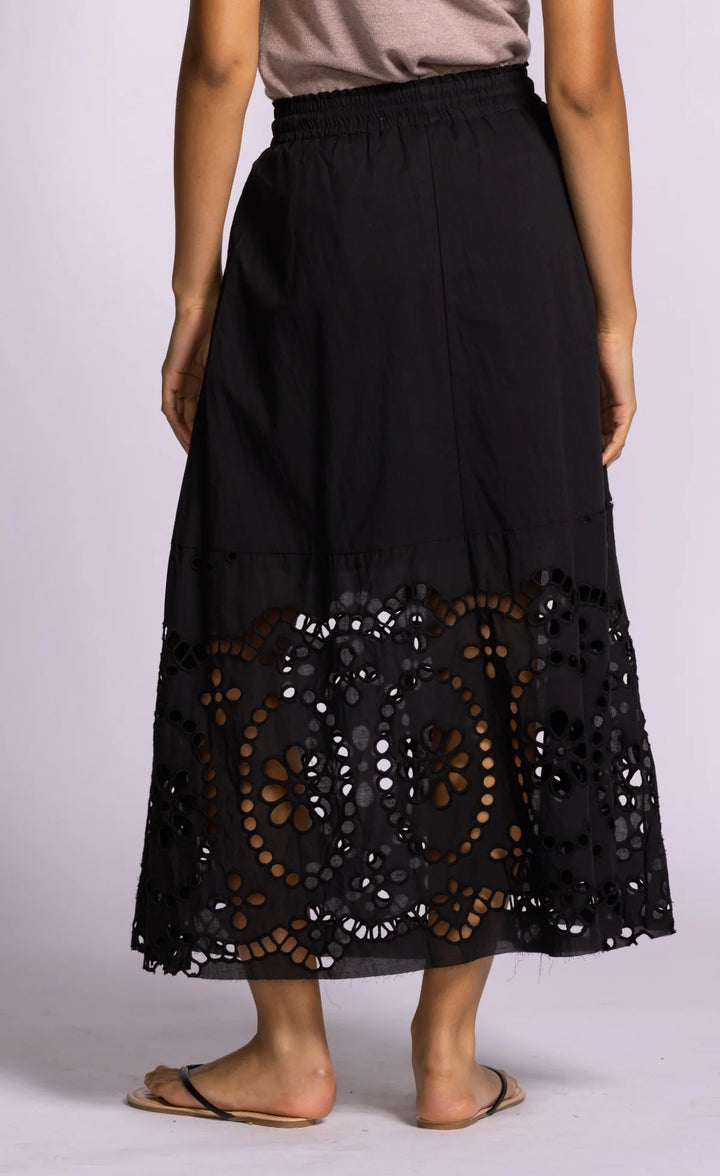Black skirt with lace detailing on a plain background