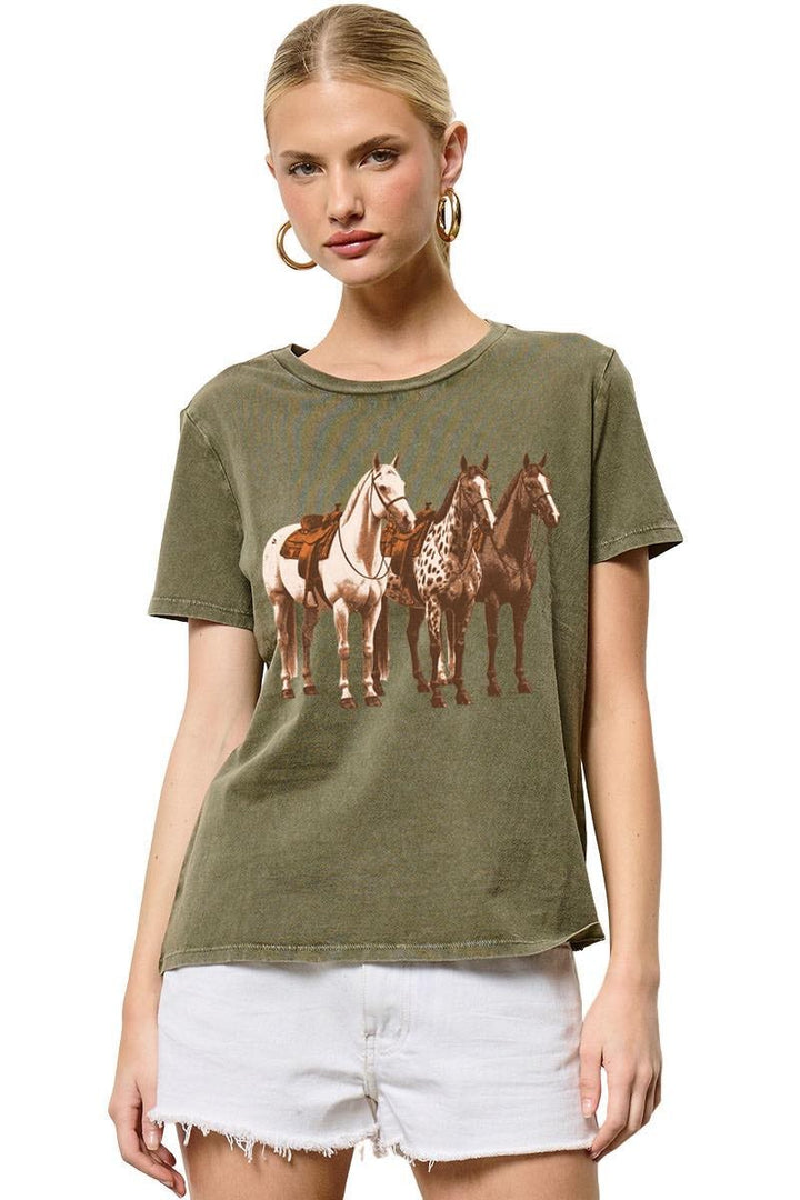 Woman wearing a green t-shirt with horse graphic design on a white background