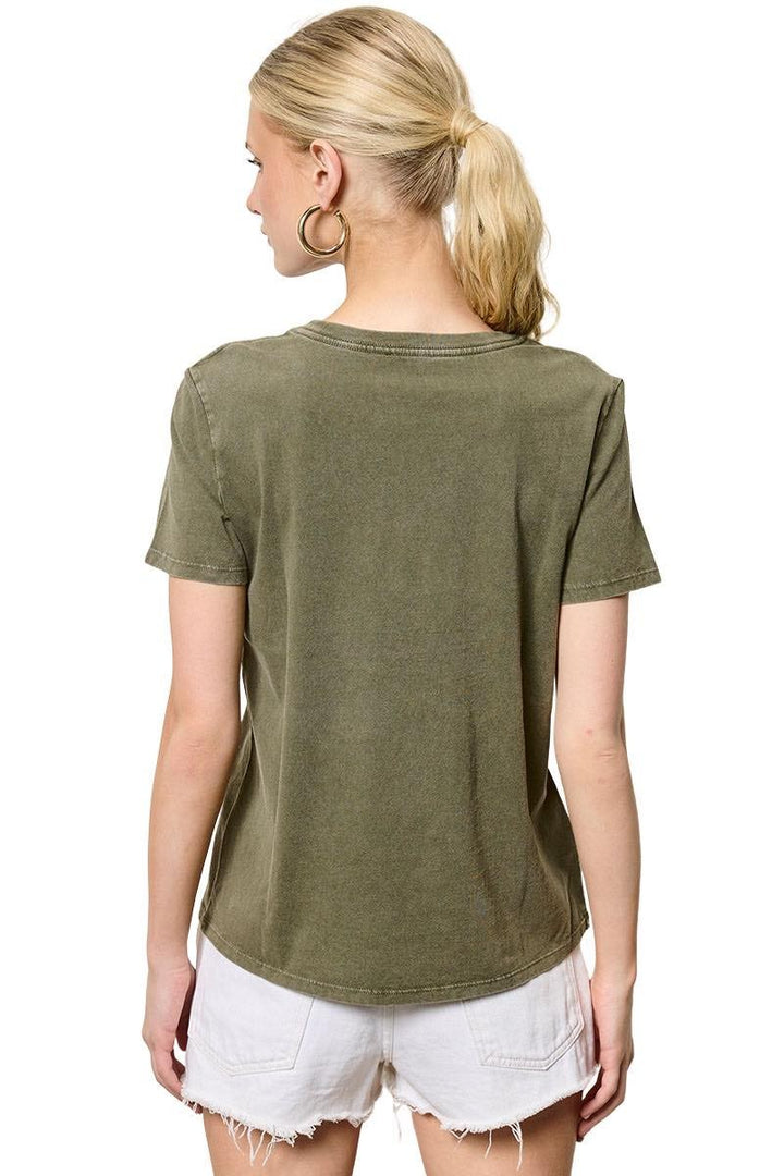 Person wearing an olive green t-shirt and white shorts on a white background