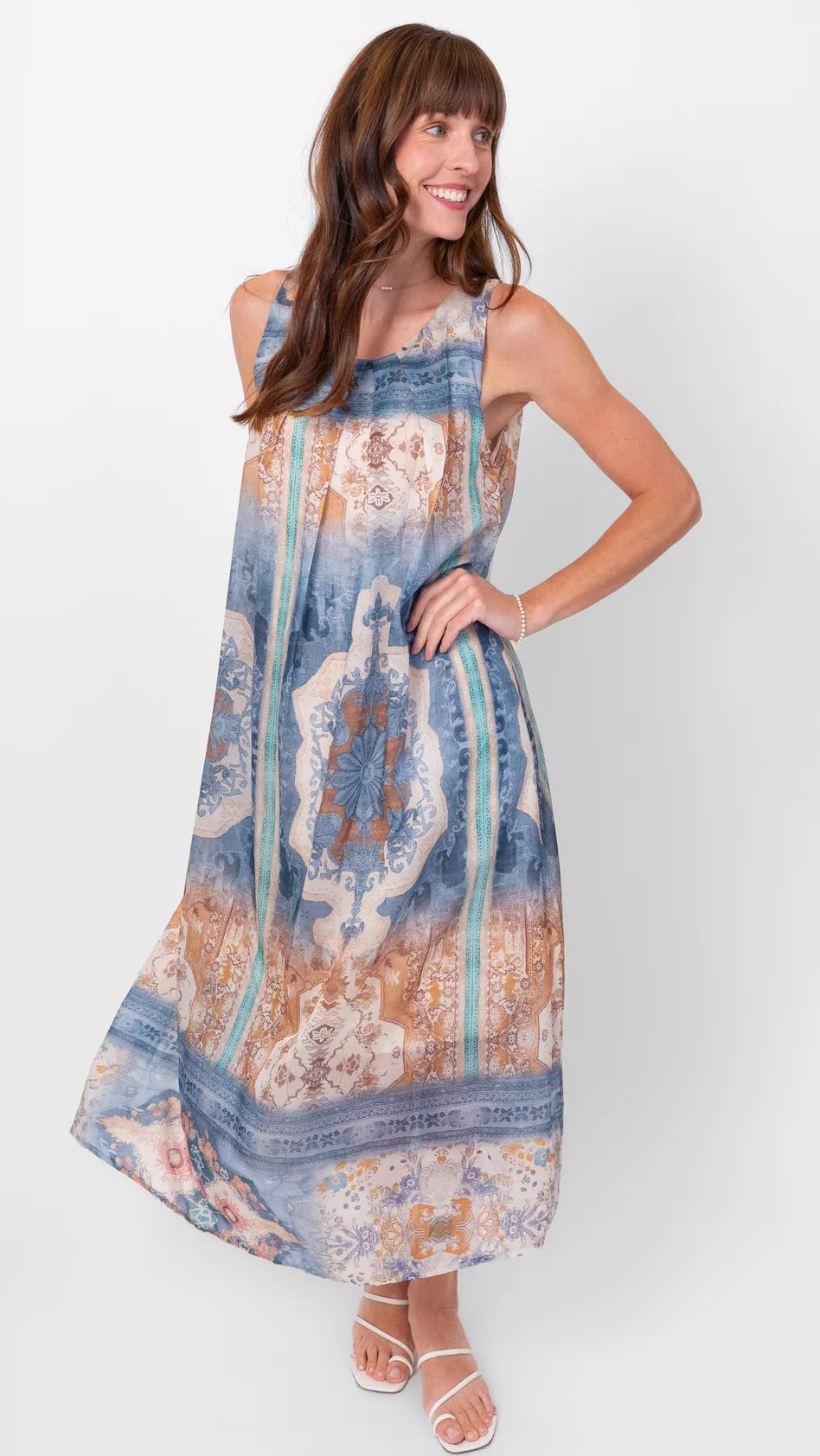 Woman wearing a patterned dress on a white background