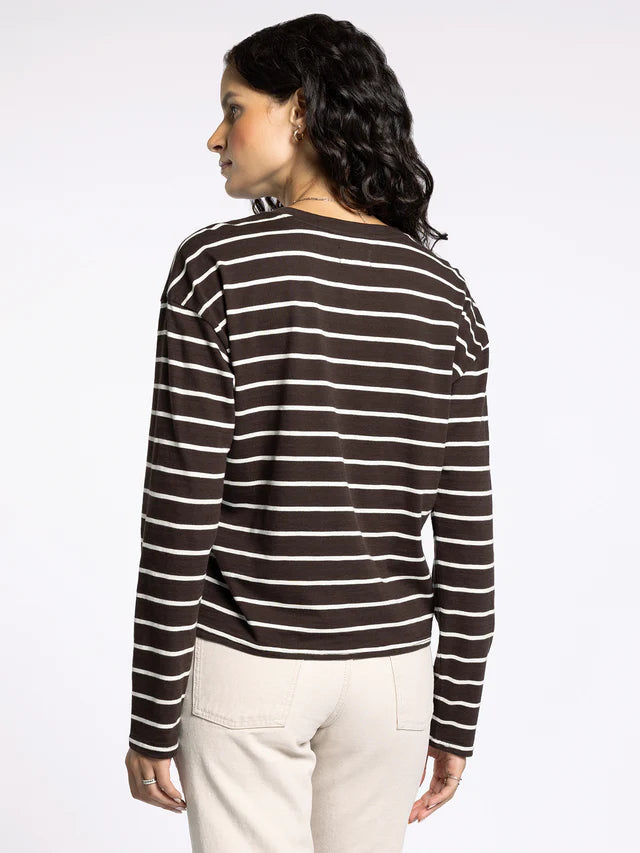 Woman wearing a black and white striped long-sleeve shirt on a white background