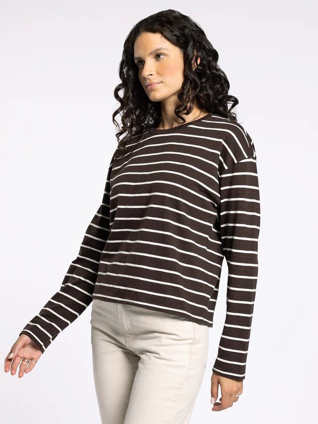 Woman wearing a brown and white striped sweater on a white background