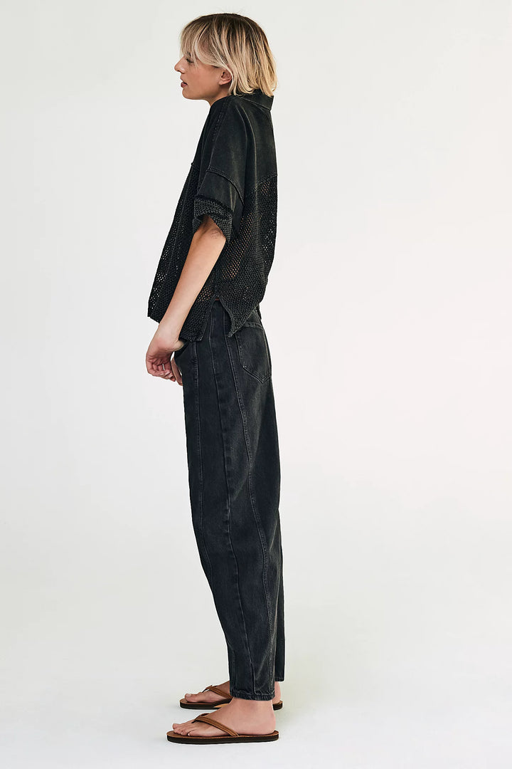 Person wearing a black jumpsuit on a white background