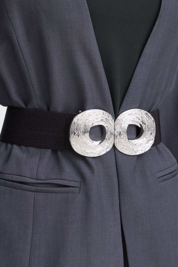 Close-up of a dark gray suit with a black belt and silver buckle.