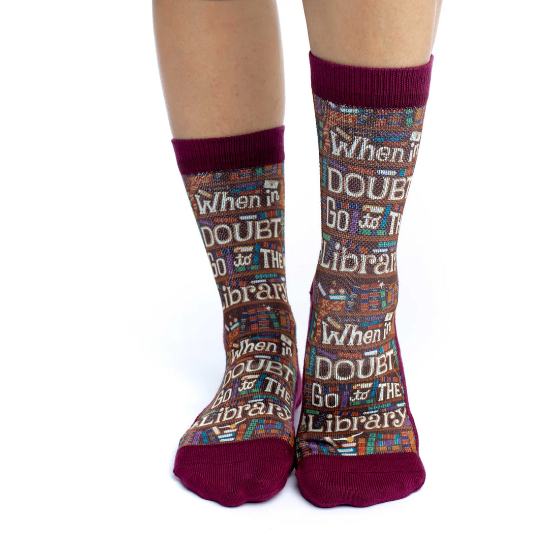Socks with library-themed text worn by a person on a white background
