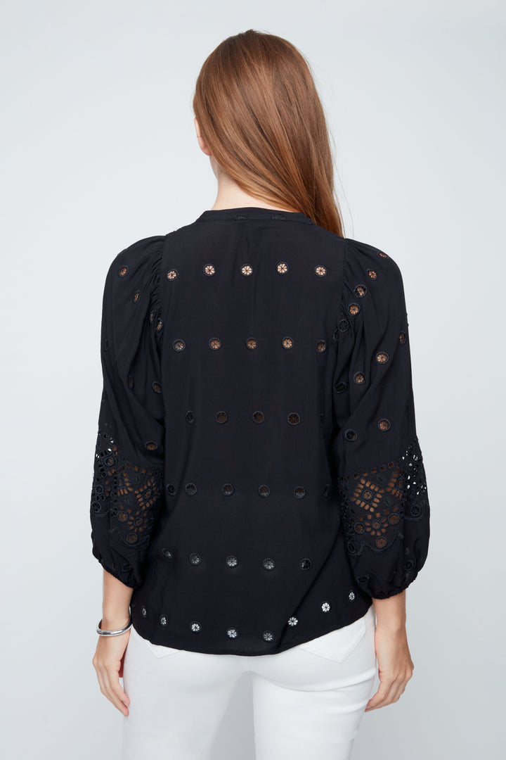 Black blouse with decorative elements on a white background