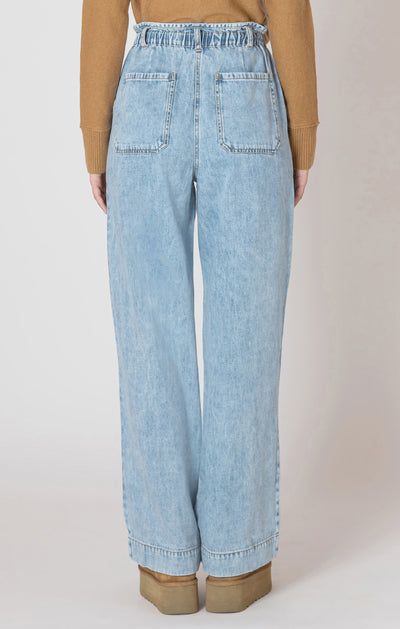 Light blue jeans worn by a person on a plain background