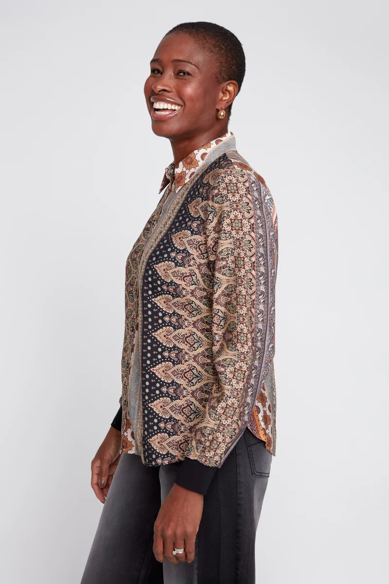 Woman wearing a patterned jacket on a white background