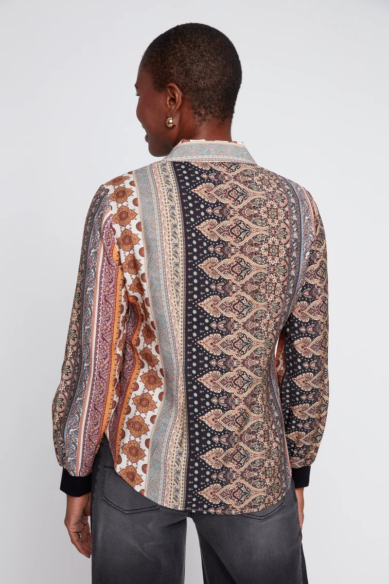 Person wearing a patterned shirt with a white background