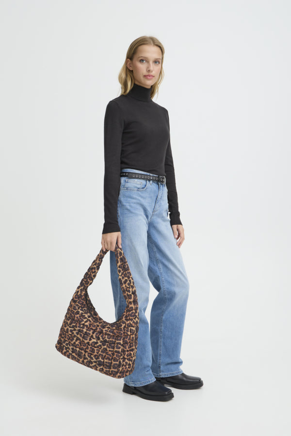 Woman holding a leopard print bag against a white background