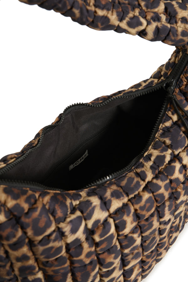 Leopard print handbag with open top showing black interior.