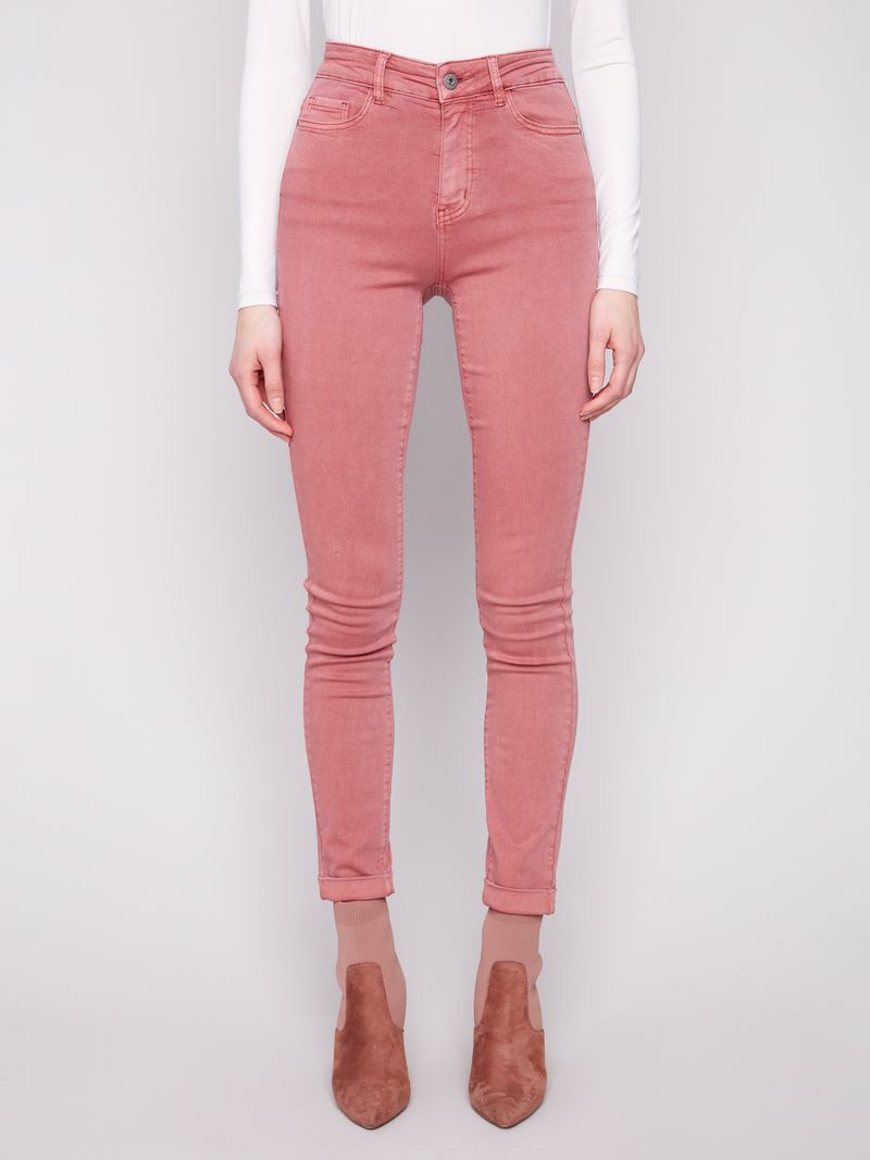 Person wearing pink jeans on a white background