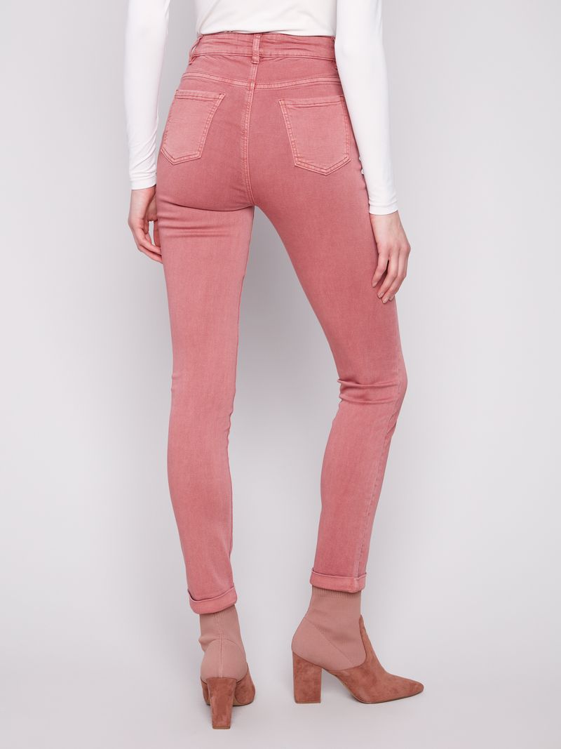 Pink jeans worn by a person on a white background