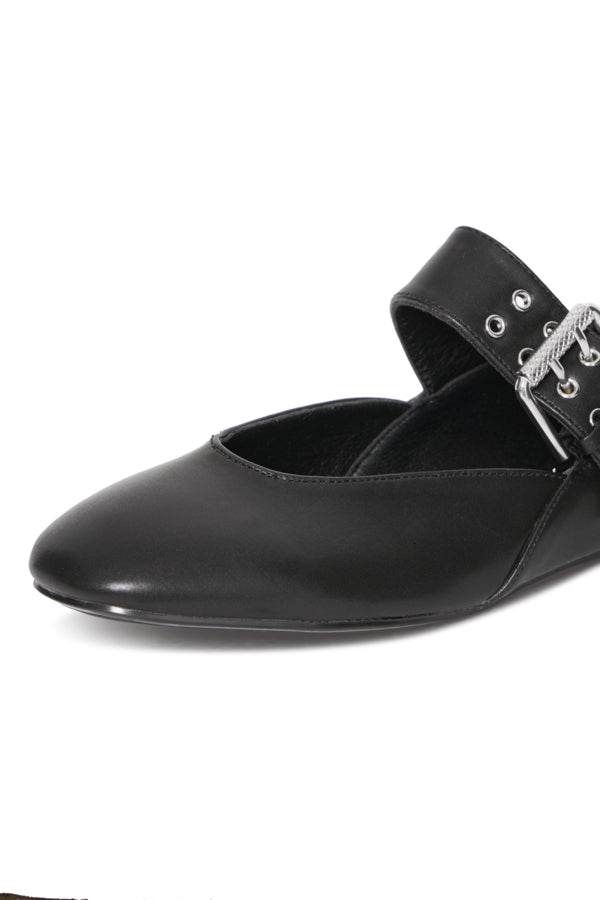 Black flat shoe with a strap and decorative elements on a white background