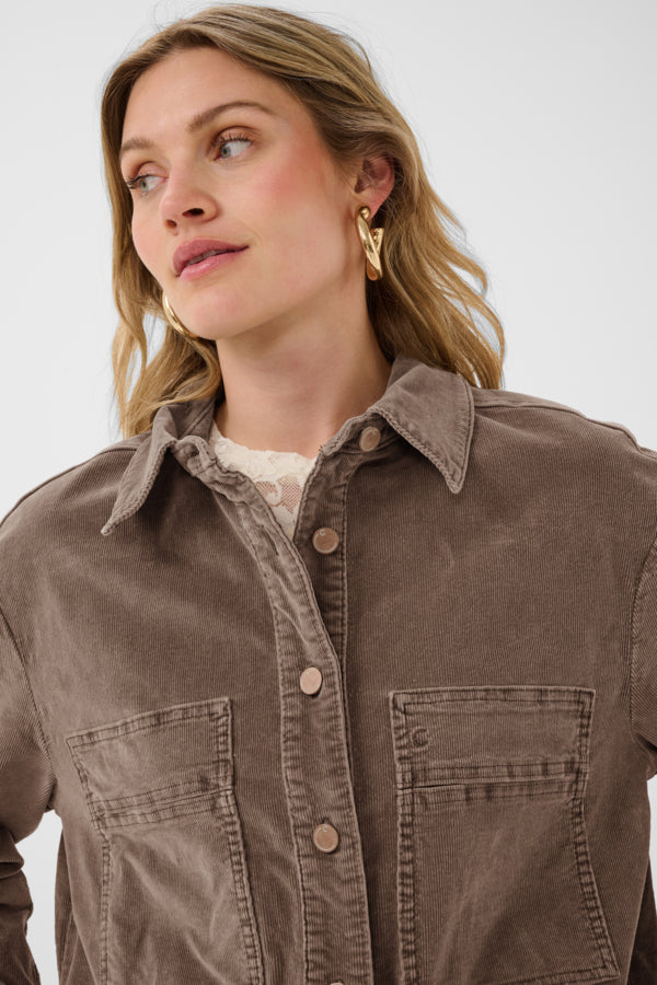 Woman wearing a brown jacket with a white background