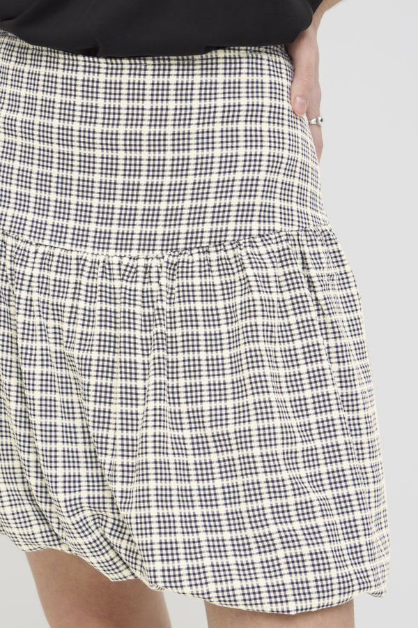 Black and white checkered skirt on a plain background