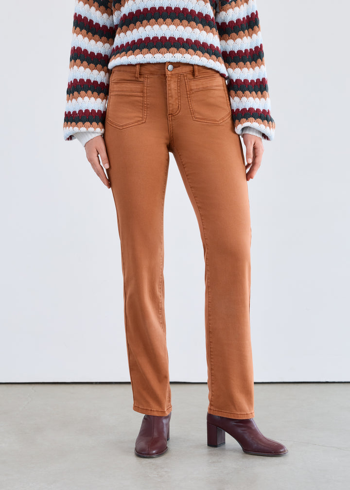 Person wearing a striped sweater, brown pants, and burgundy shoes on a white background