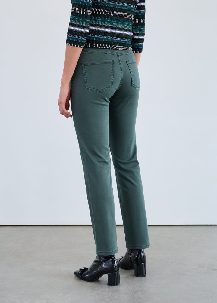 Person wearing green pants and a striped sweater on a plain background