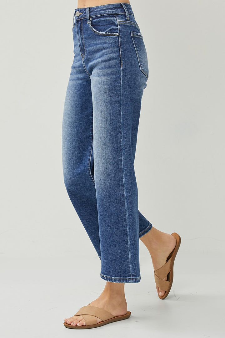 Blue jeans worn by a person on a light gray background