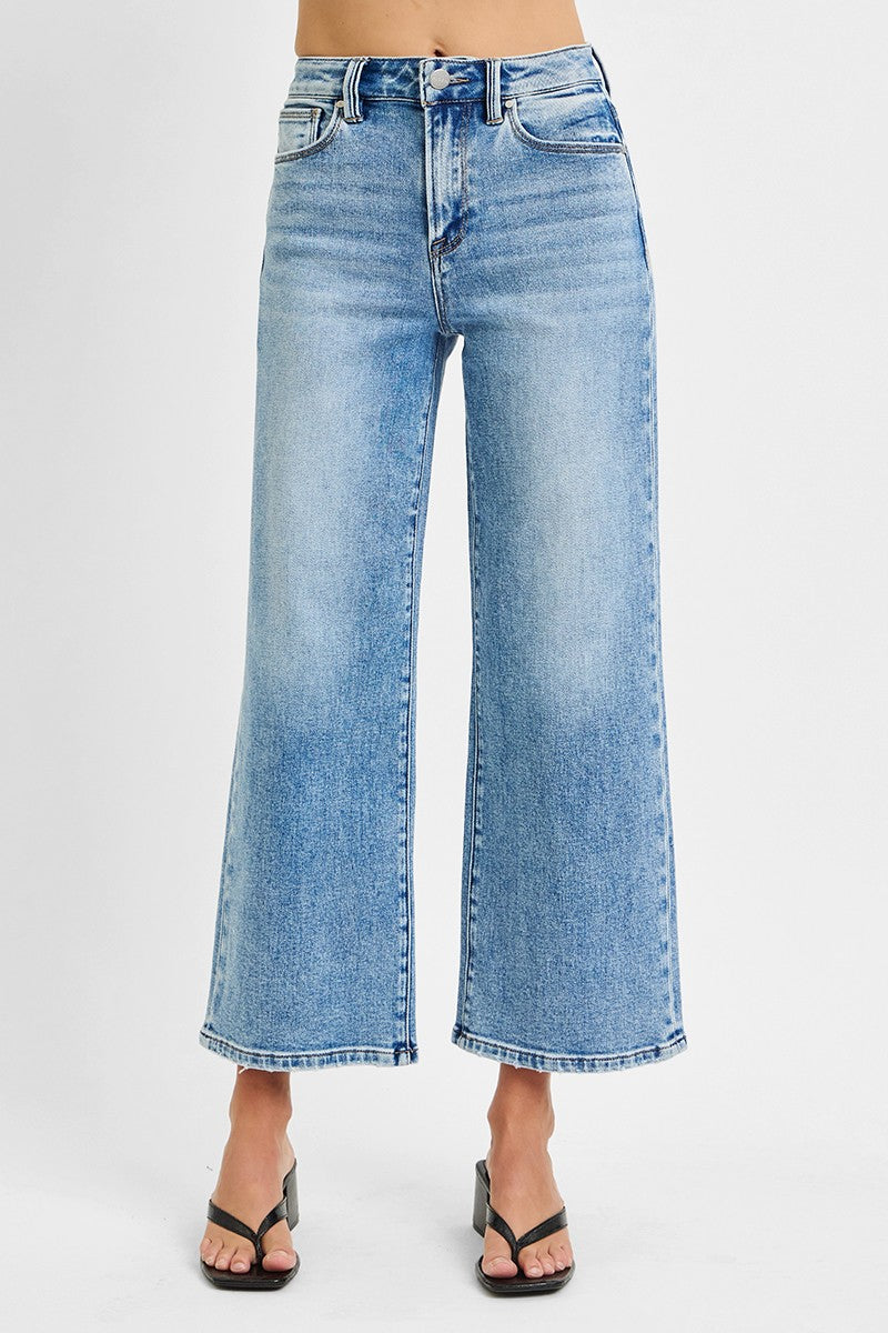 Blue jeans worn by a person on a white background